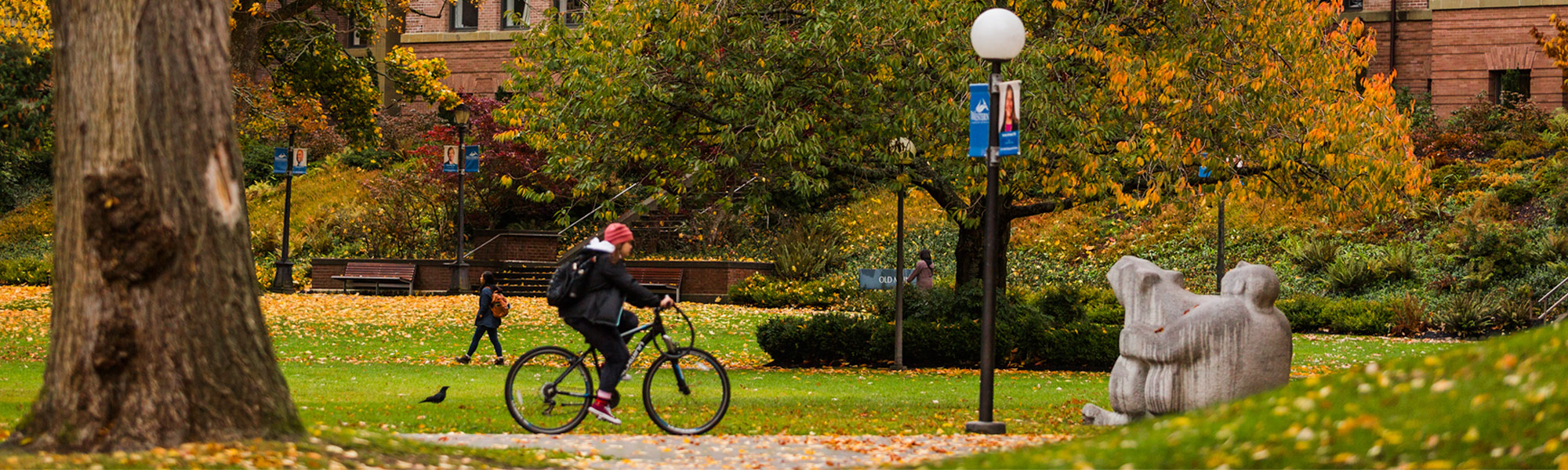 Western in the fall. Students bike and walk on brick pathways.