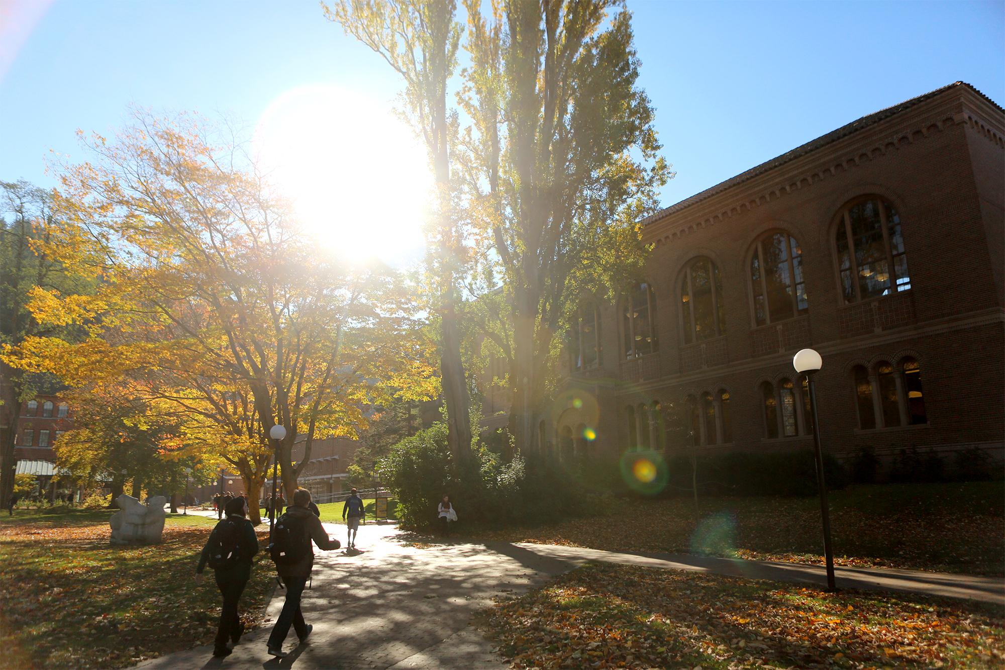 Students walking onto campus in the fall.