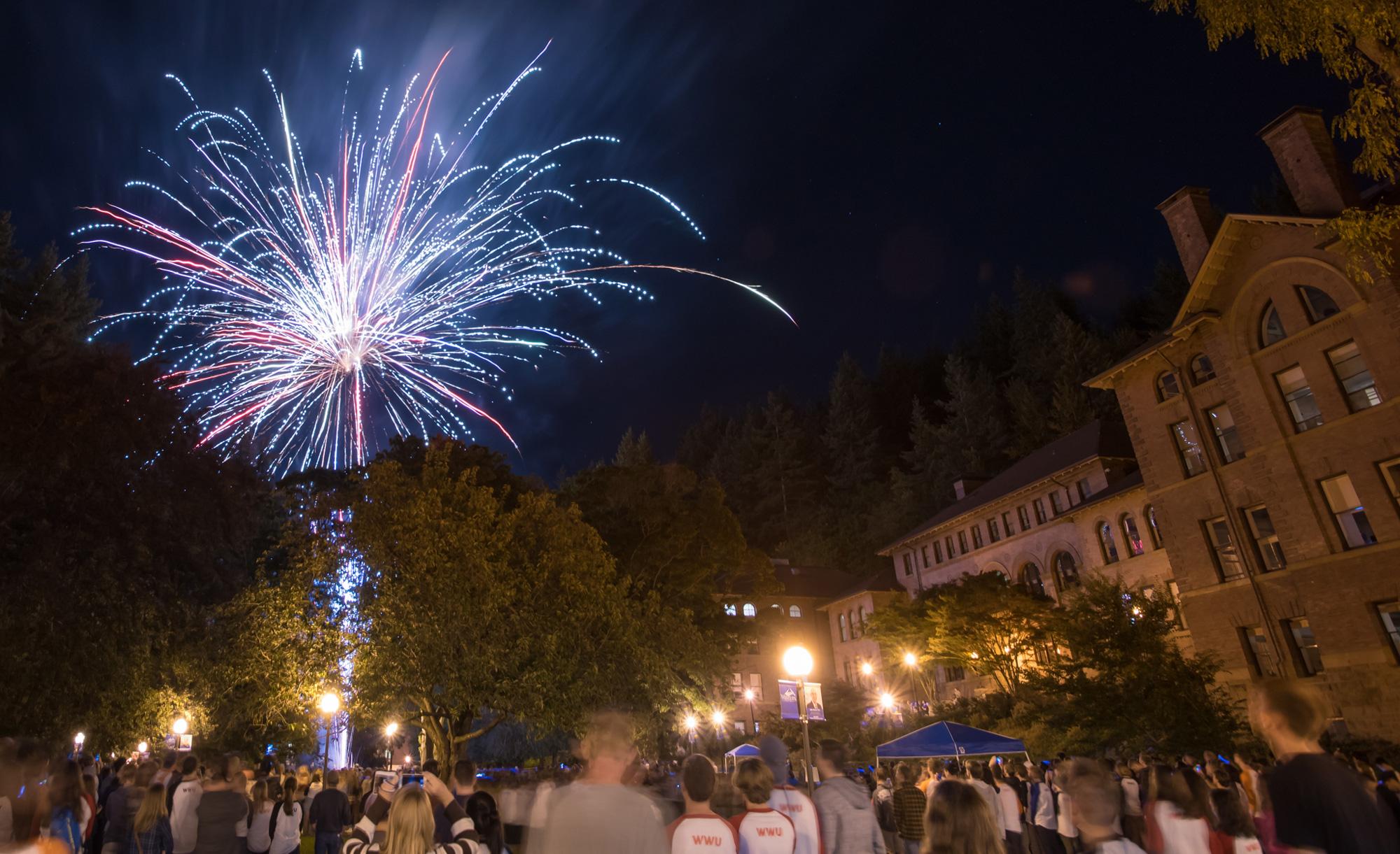 Fireworks light up the sky in front of Old Main.