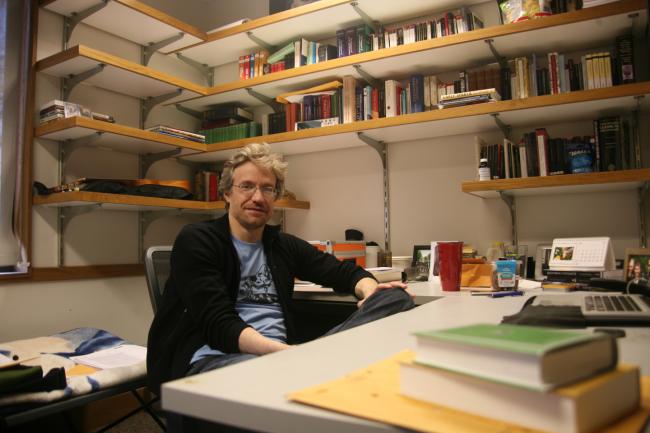 Dr. Tristan Goldman sitting at his desk